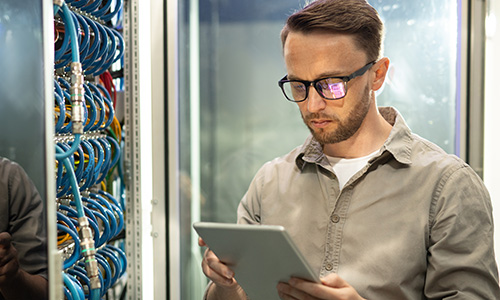 male network technician checking data on tablet